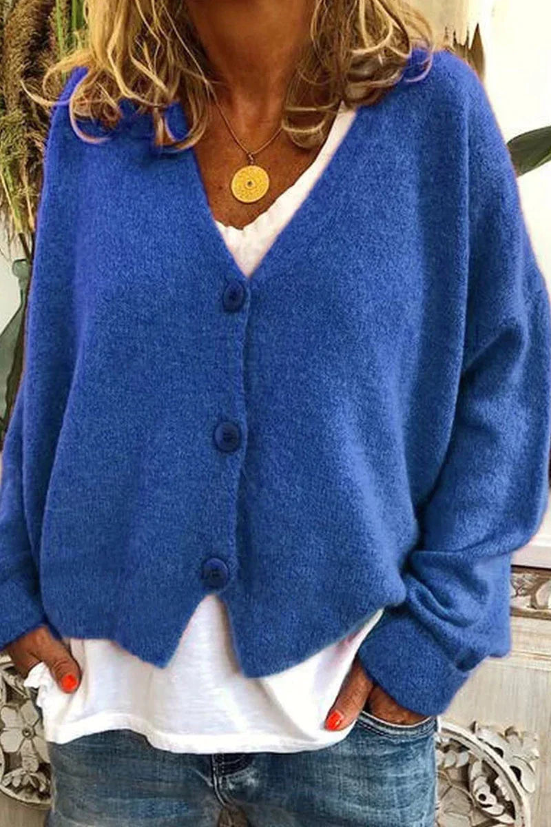 "Aspen vest in geel met elegant patchwork, V-hals en lange mouwen. Knus en trendy voor dames, ideaal voor elke gelegenheid."