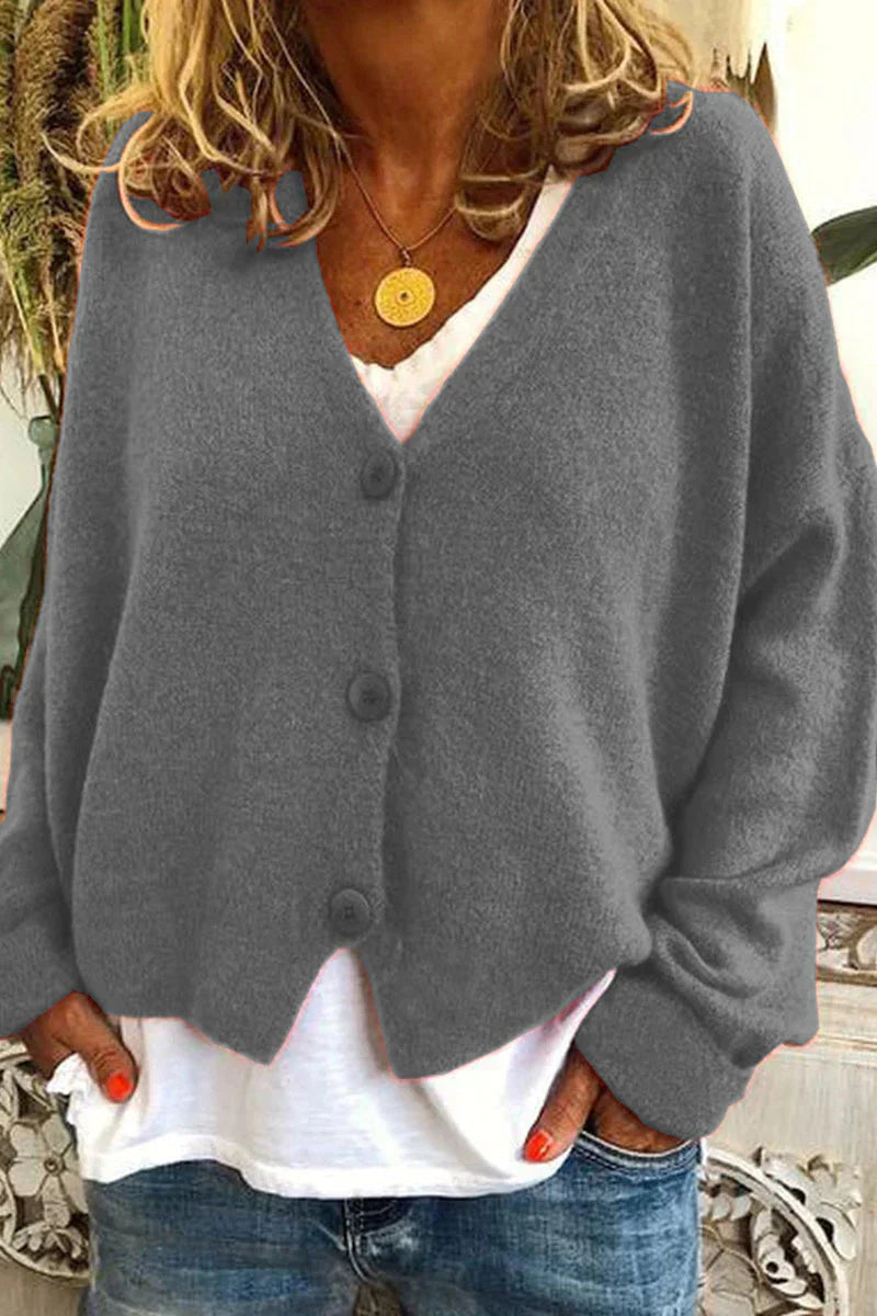 "Aspen vest in geel met elegant patchwork, V-hals en lange mouwen. Knus en trendy voor dames, ideaal voor elke gelegenheid."