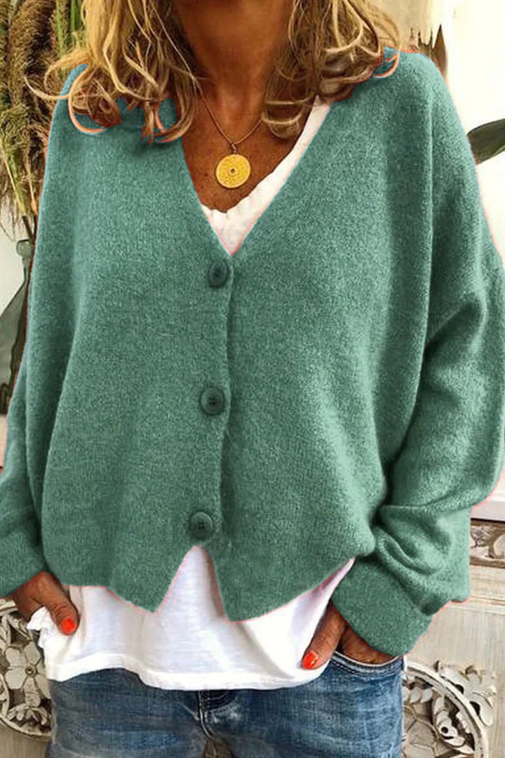 "Aspen vest in geel met elegant patchwork, V-hals en lange mouwen. Knus en trendy voor dames, ideaal voor elke gelegenheid."