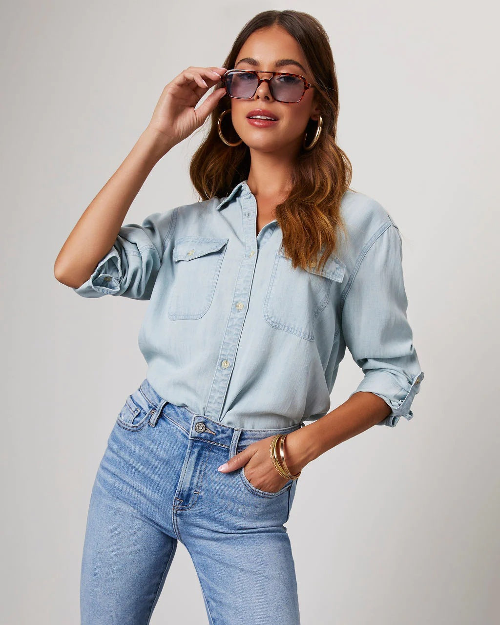 Blauw gekleurde damesblouse met knoopsluiting en lange mouwen.