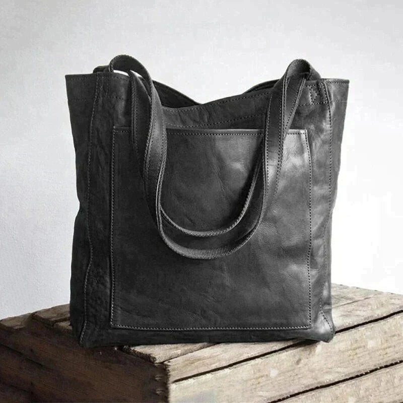 Zwarte vegan leerlook dames schoudertas, ruime en tijdloze handtas voor al je essentiële spullen.