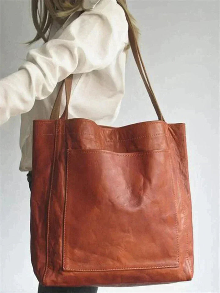 Veelzijdige zwarte dames handtas, gemaakt van leerlook materiaal, perfect voor zowel werk als vrije tijd.