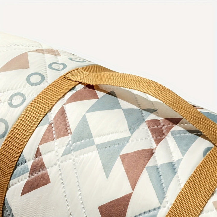 Compact opgevouwen picknickdeken met handvat, makkelijk mee te nemen naar strand of park.