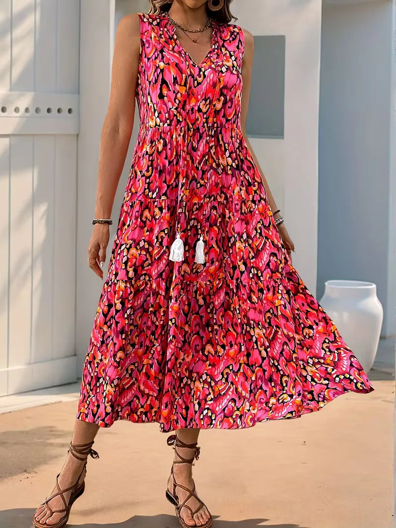 Dames bohemian midi jurk met A-lijn model, V-hals en speelse, kleurrijke kwastjes.