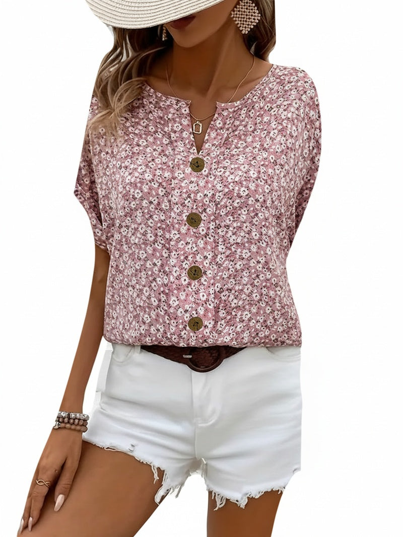 Dames blouse korte mouw met elegante bloemenprint. Roze loose fit zomerblouse met ronde hals en knoopjes.