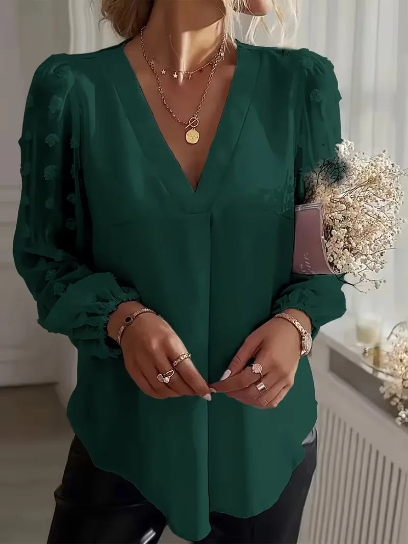 Damesblouse met doorschijnende lange mouwen en V-hals, ideaal voor een feestelijke gelegenheid.