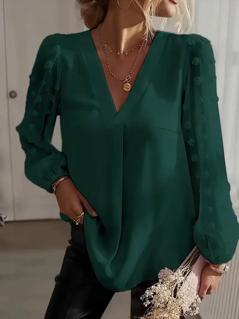 Mooie damesblouse met doorschijnende mouwen, V-hals en een relaxte pasvorm.
