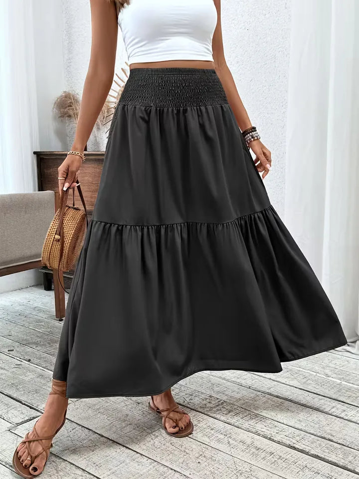 Dames bohemian A-lijn maxi rok met smock taille, ideaal voor zomer en vakantie.