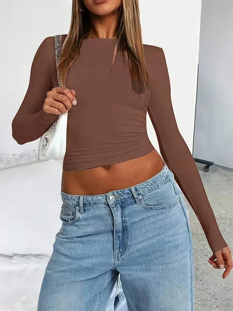 Slim fit cropped dames longsleeve met ronde hals; de perfecte basis voor een trendy gelaagde look.