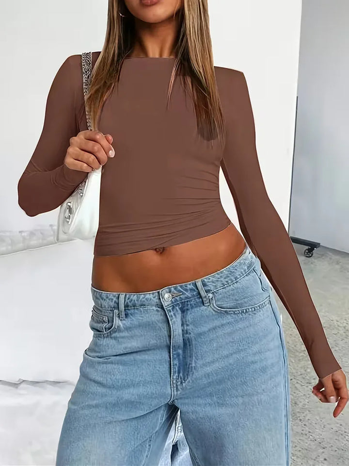 Slim fit cropped dames longsleeve met ronde hals; de perfecte basis voor een trendy gelaagde look.