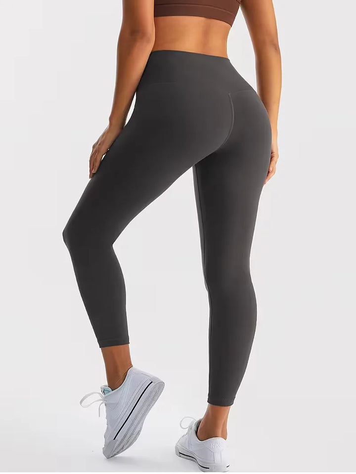 Dames high-waisted slim fit sport legging. Stretch en enkellengte voor yoga, fitness en casual comfort.