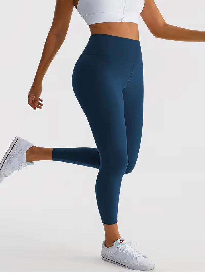 Effen stretch dames legging, high-waisted en slim fit. Voor fitness, yoga en casual lente stijl.