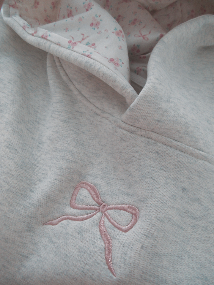 Dames hoodie met roze strik op de rug, ideaal voor casual mode en comfortabele stijl.