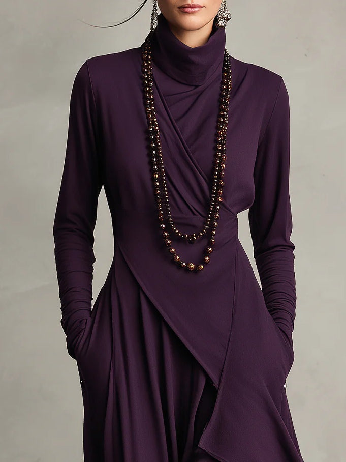Dames maxi jurk met hoge col, lange mouwen en praktische zakken. Asymmetrische rok, bohemian stijl voor een elegante look.