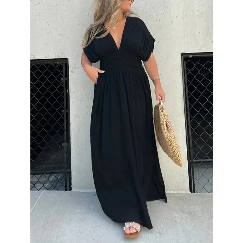 Elegante damesjurk met V-hals en hoge split, perfect voor warme zomeravonden en feesten.