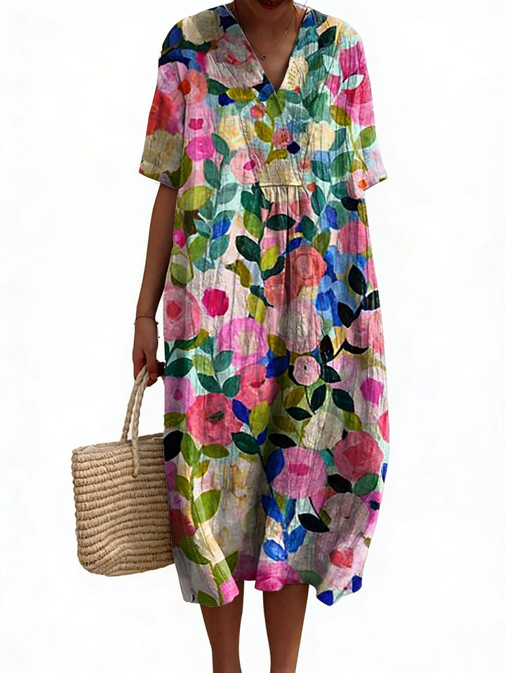 Dames midi jurk met vrolijke bloemenprint, V-hals en korte mouwen. Comfortabele zomerjurk voor de lente.