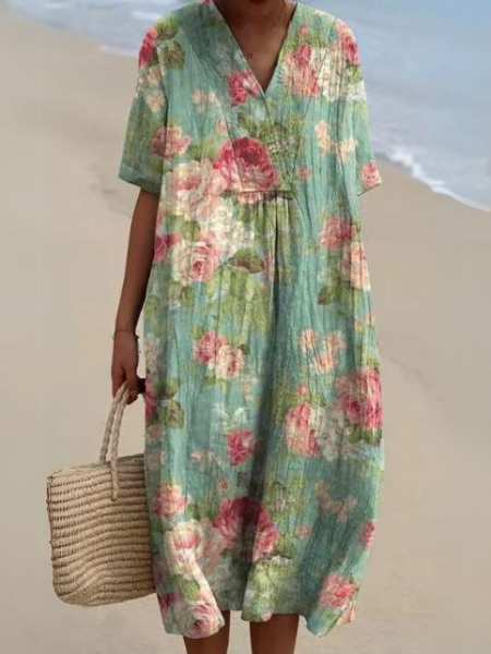 Gedetailleerde bloemenprint en stof van de dames midi jurk met V-hals en korte mouwen. Zomerse elegantie.