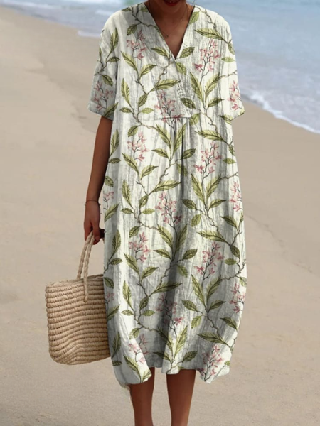 Trendy dames midi jurk met bloemenprint, V-hals en korte mouwen. Casual zomerjurk, ideaal voor zonnige dagen.