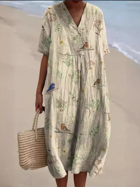 Comfortabele dames midi jurk met bloemenprint en V-hals. Korte mouwen en flowy design voor zomer en lente.