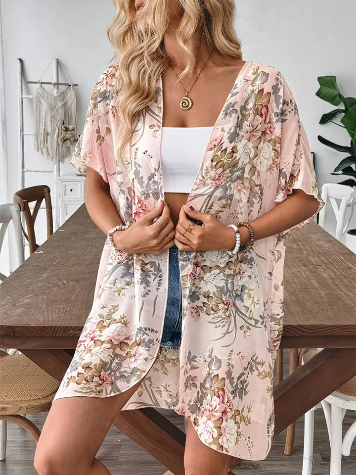 Trendy dames open front cardigan, lange mantel met bloemenprint. Ideale zomerkleding en strand accessoire.