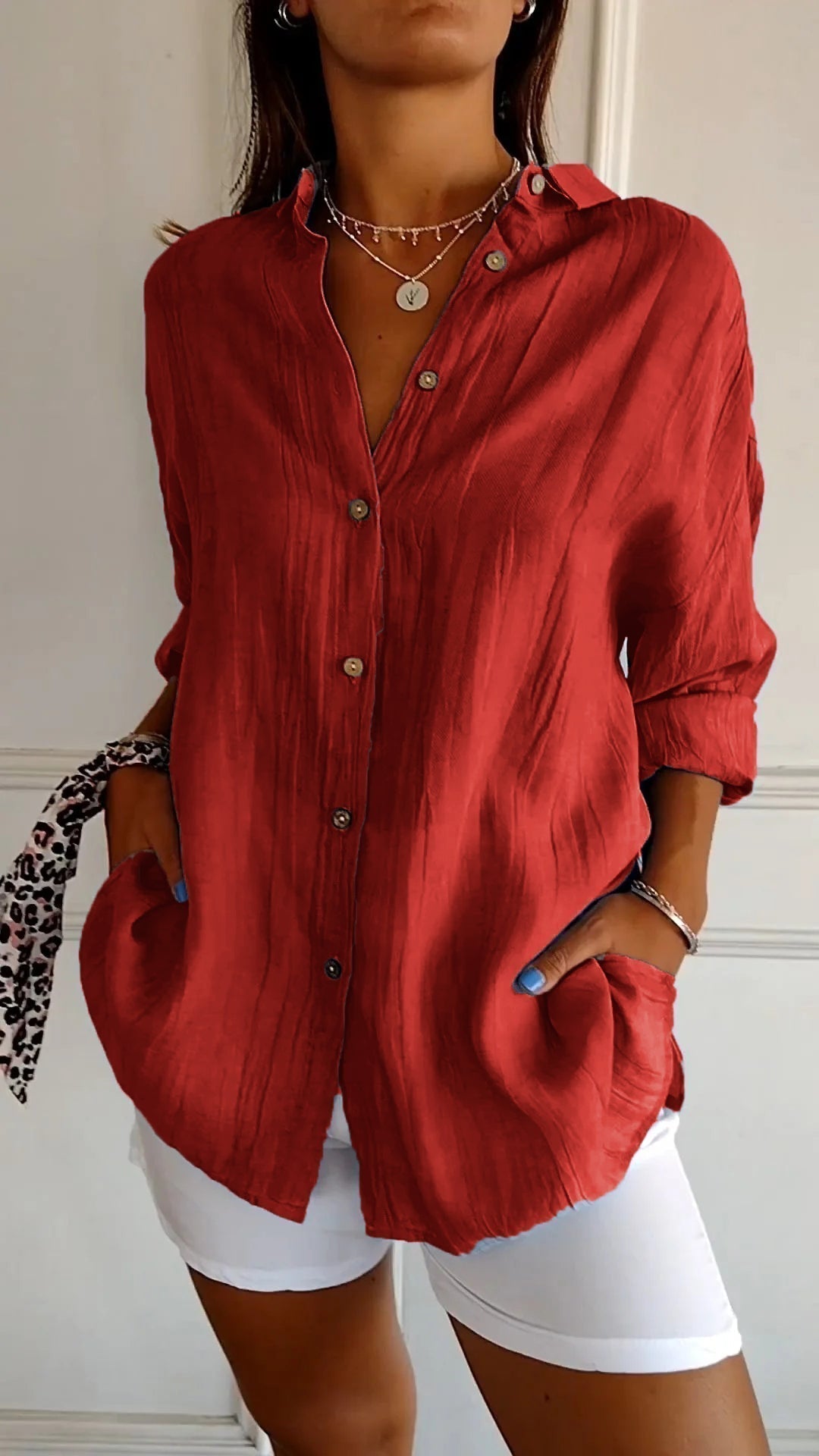 Detailopname van de knopjes en ruime zijzakken op een comfortabel oversized dames shirt.