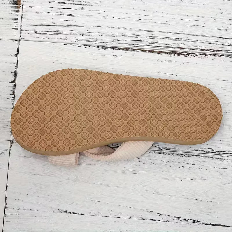 Beige platte sandaal voor dames, met elegante boho strik en subtiele kralenversiering.