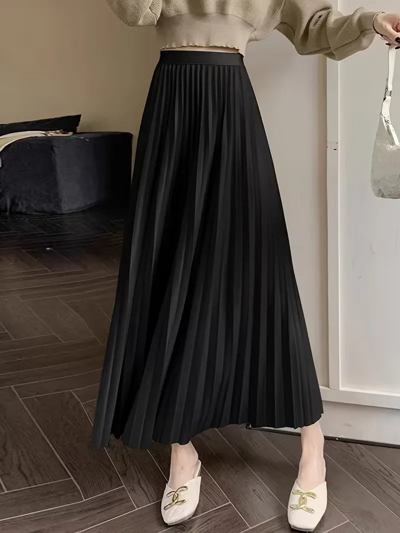 Damesmodel draagt elegante plooirok met hoge taille, midi lengte, comfortabel en stijlvol. Perfect voor zakelijk.
