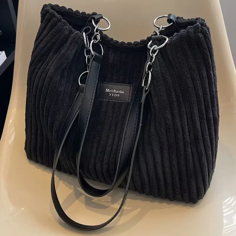 Elegante dames schoudertas met ribbeltextuur. Perfecte casual corduroy tas voor herfst/winter.