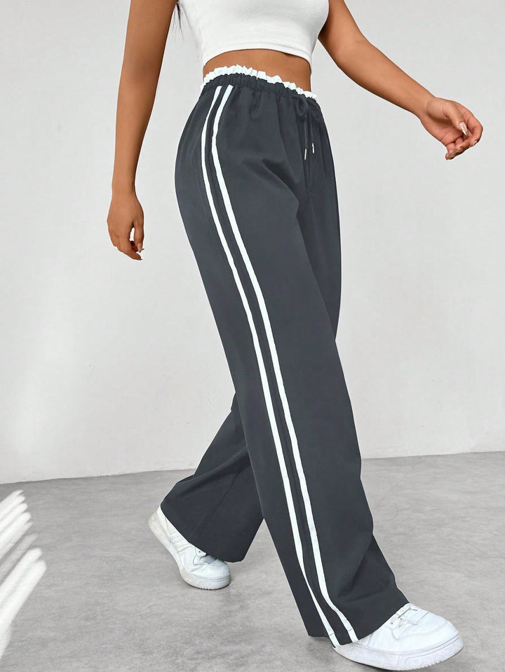 Vrouwen sportieve wide-leg broek met strepen, een stijlvolle keuze voor trendy casual outfits.
