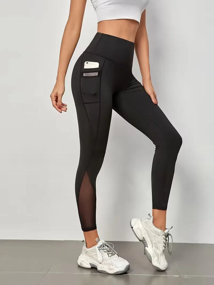 Comfortabele marineblauwe dames sportlegging met hoge taille, stijlvolle mesh en slim fit pasvorm.