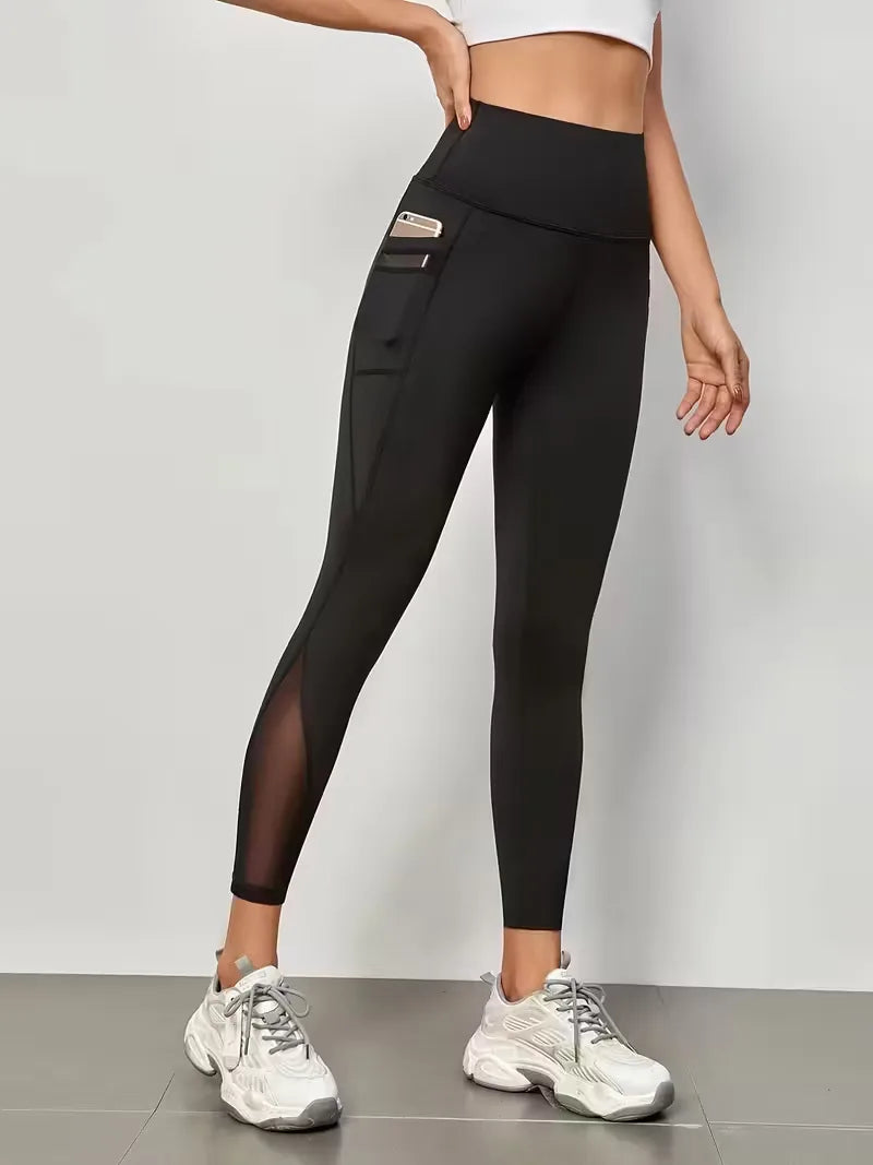 Dames fitness legging, hoge taille, trendy mesh inzetten en zijzakken, perfect voor sportkleding.