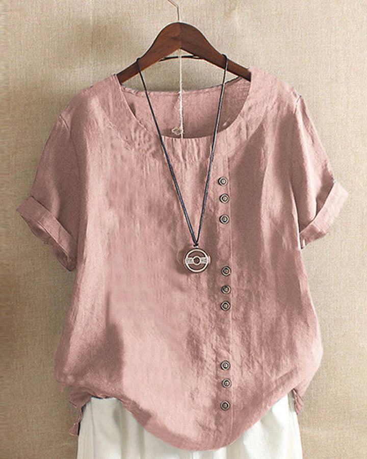 Trendy dames top met knoopdetails, korte mouwen. Ideaal voor een chique of relaxte outfit.