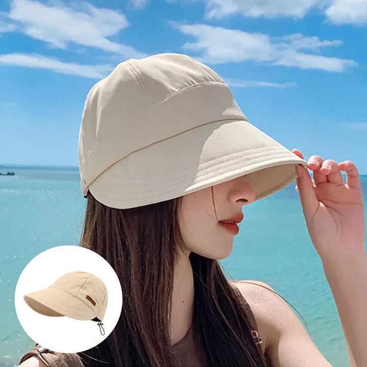 Khaki/beige dames UV-beschermingshoed met brede rand. Ideaal voor zonbescherming tijdens zomerse dagen.