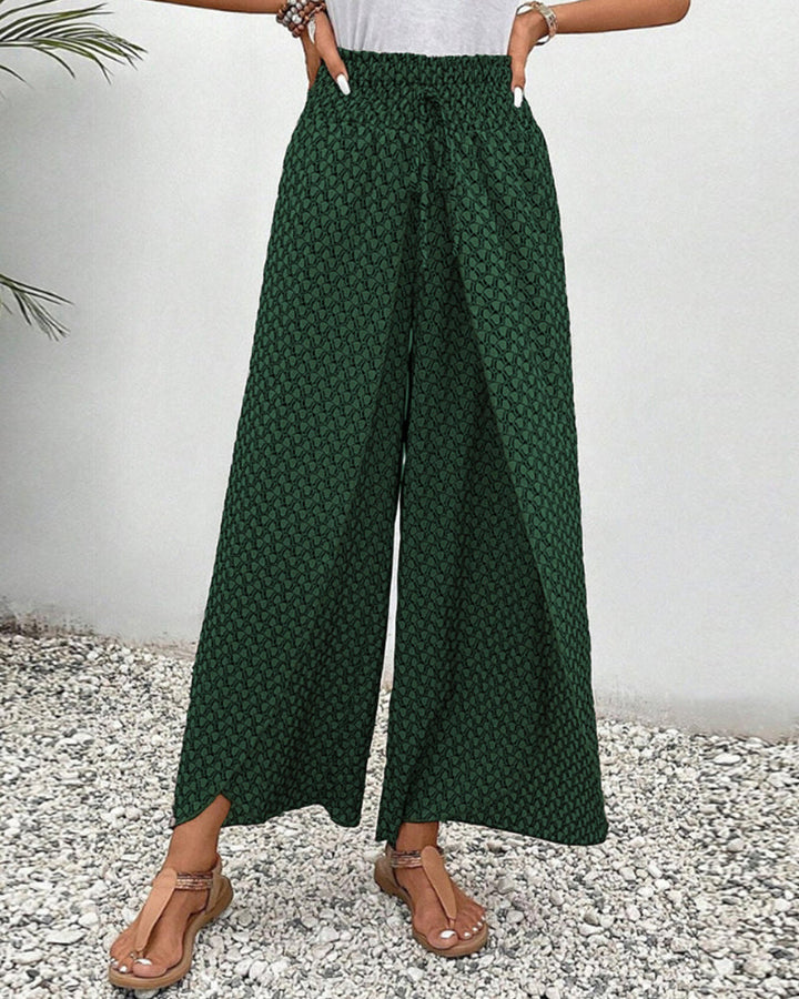 Casual elegante damesbroek met wijde pijpen, een levendig geometrisch patroon en comfortabele elastische taille.