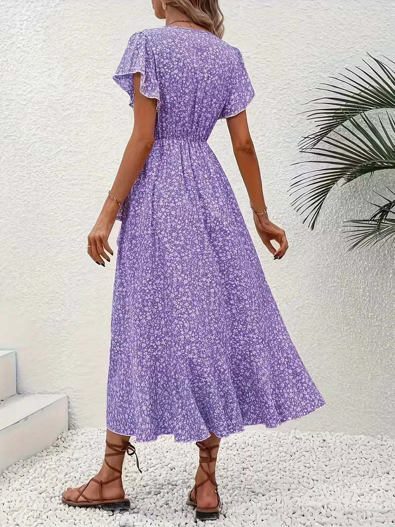 Damesjurk: zomerse wikkeljurk met bloemenprint, midi lengte, perfect voor elke gelegenheid.