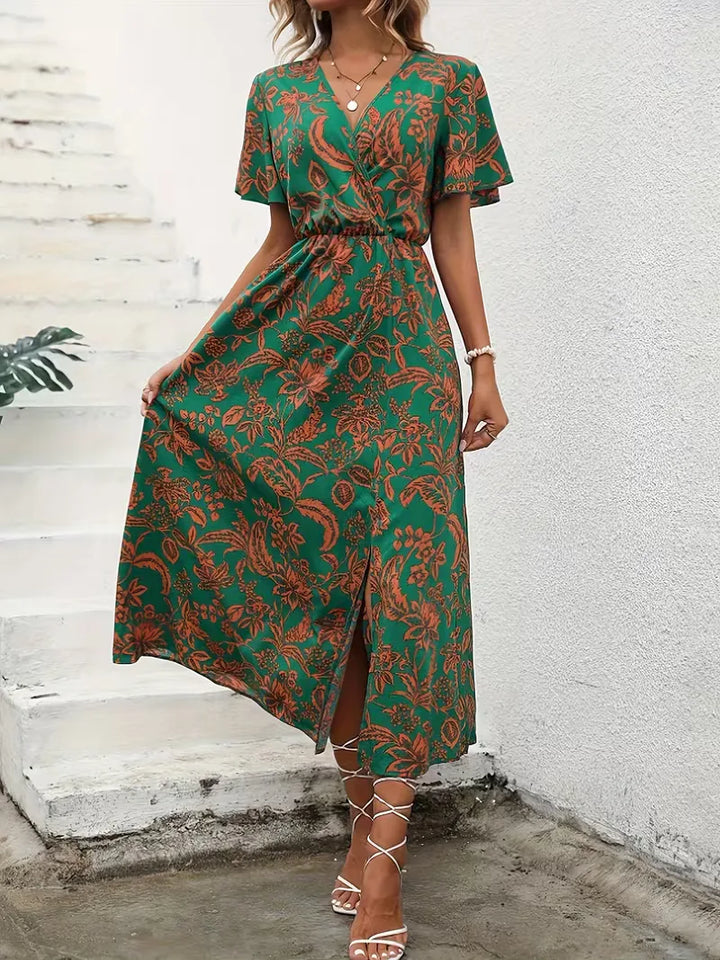 Elegante dames zomerjurk: midi wikkeljurk met vrolijke bloemenprint, V-hals, korte mouwen. Geschikt voor casual en strand.
