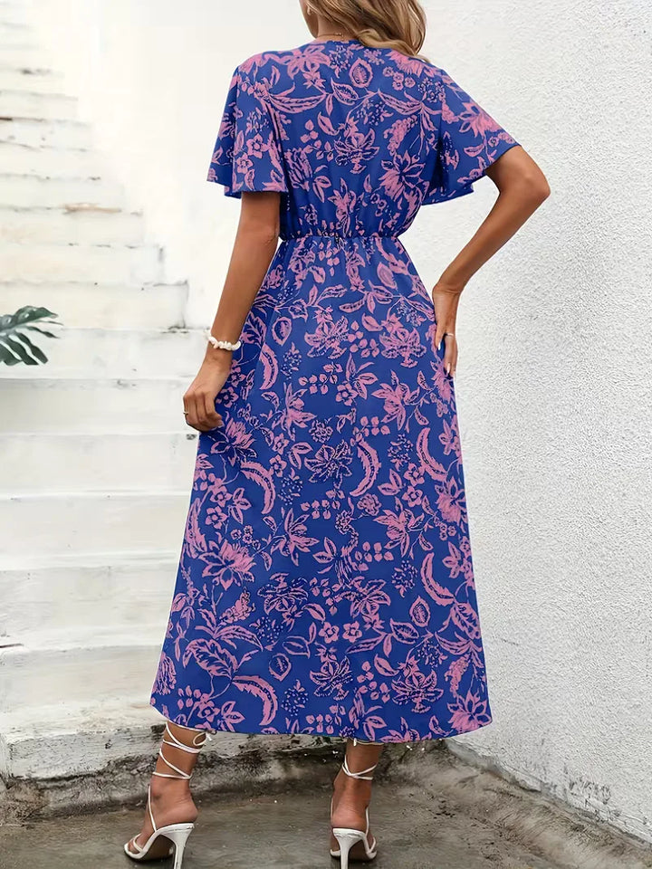 Bohemian wikkeljurk dames, bloemenprint, midi lengte, V-hals. Casual zomerjurk, perfect voor strand of vrije tijd.