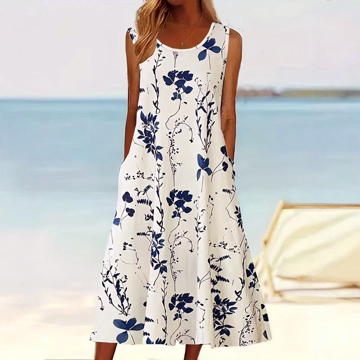 Elegante dames mouwloze A-lijn midi jurk met levendige bloemenprint, ideaal voor zomerse dagen en strand.