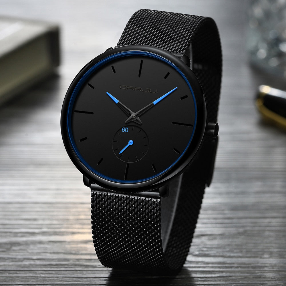 "Dun minimalistisch herenhorloge met elegante zwarte wijzerplaat, roestvrijstalen mesh-band en luxe uitstraling."