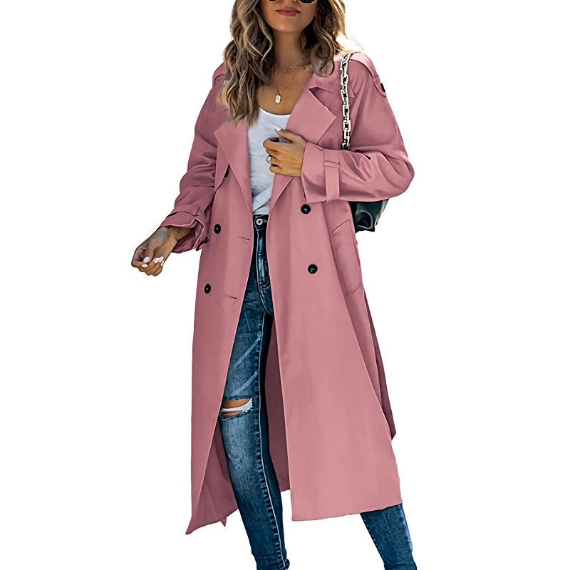 Modebewuste vrouw draagt een nieuwe collectie klassieke lange trenchcoat in beige, ideaal als overgangsjas.