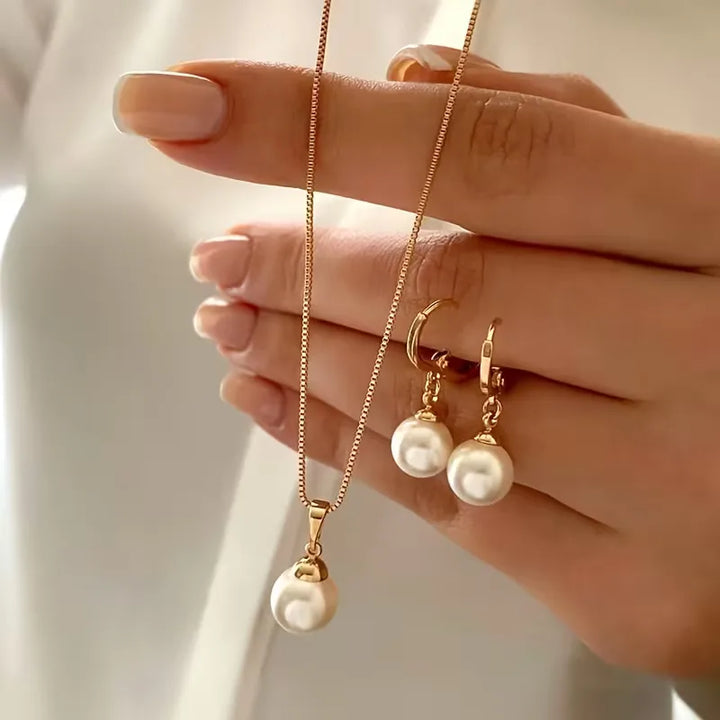 Elegant dames parelsieraden set met goudkleurige ketting, faux parels en bijpassende oorbellen.