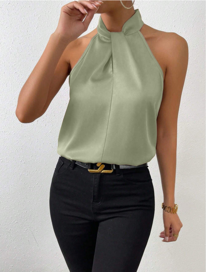 Dames haltertop, mouwloos, met een opvallende gedraaide hals. Ideaal voor zomerse feestjes.