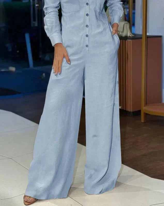 Vrolijke oranje dames jumpsuit, elegante pasvorm met wijde pijpen en lange mouwen. Trendy dameskleding.