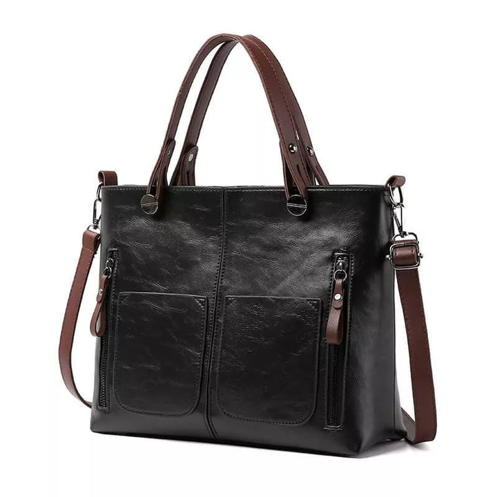 Voorkant van de leren schoudertas voor dames, met elegante sluiting. Een luxe en tijdloos accessoire.