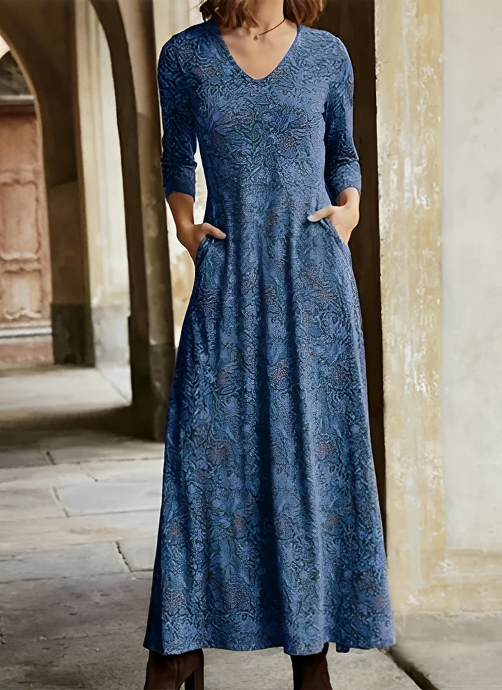Elegante dames maxijurk met vloeiend bloemenpatroon en lange mouwen, perfect voor feestjes.