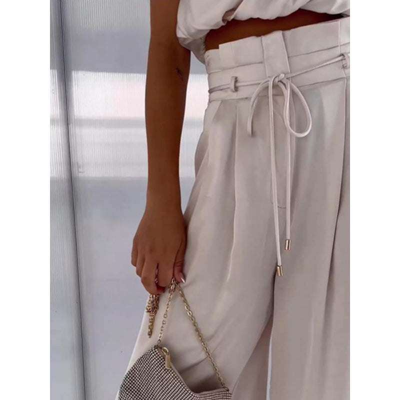 Feestelijke dames outfit: elegante top met één schouder en bijpassende broek. Perfect voor de zomer.