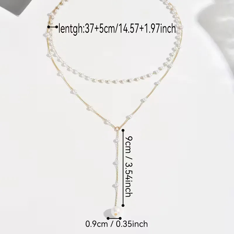 Modieuze dames ketting: goudkleurig, Y-vormig, versierd met elegante parels. Chic accessoire.