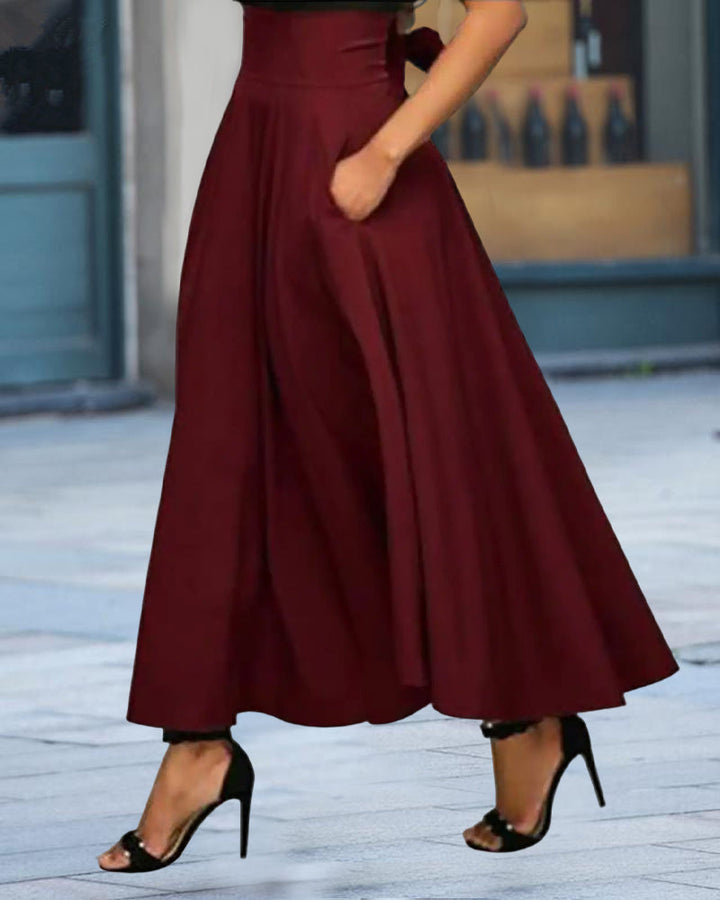 Stijlvolle lange damesrok met hoge taille; elegante, veelzijdige mode voor formele events of casual zomerlooks.