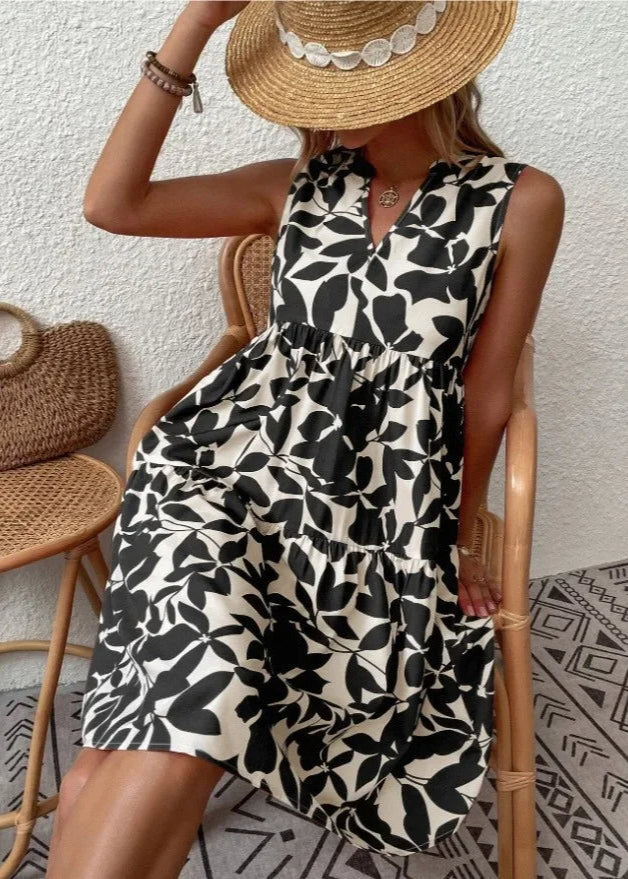 Elegante midi-jurk met V-hals, zomerse bloemenprint, luchtige stof, mouwloos, ideaal voor warme dagen en stijlvolle uitstrali