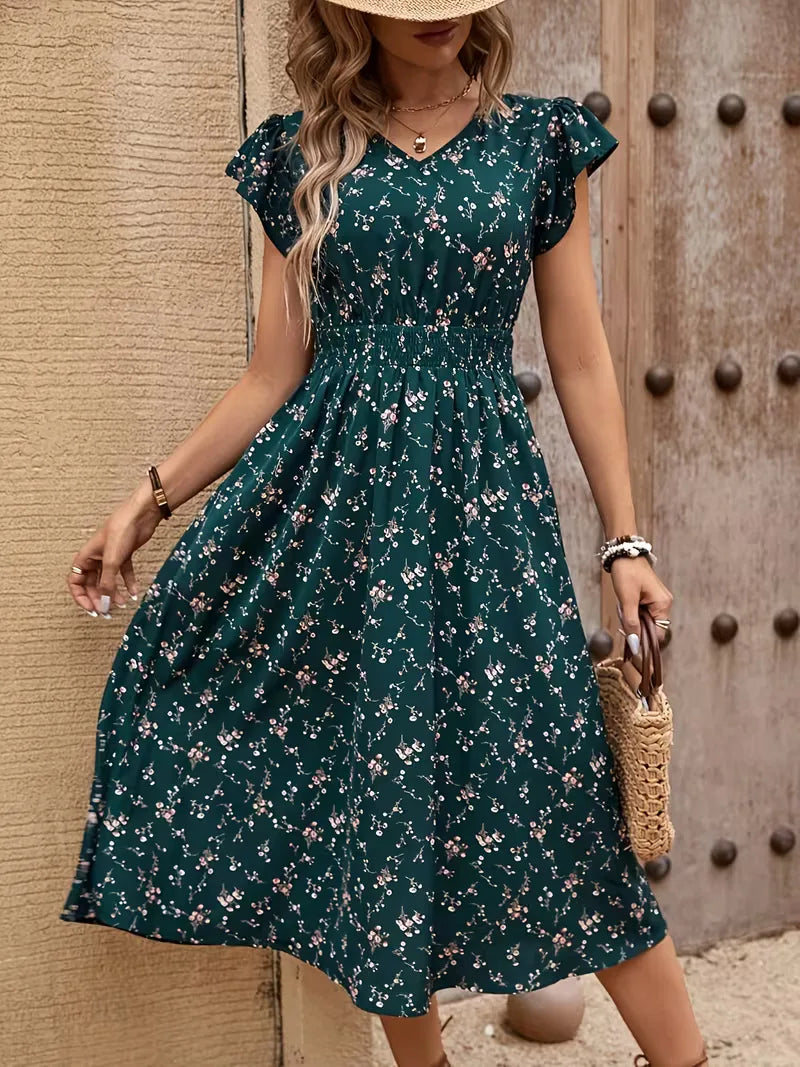 Casual én elegante petrol dames A-lijn jurk met bloemenprint. Ideaal als zomerjurk met V-hals en comfortabele stof.
